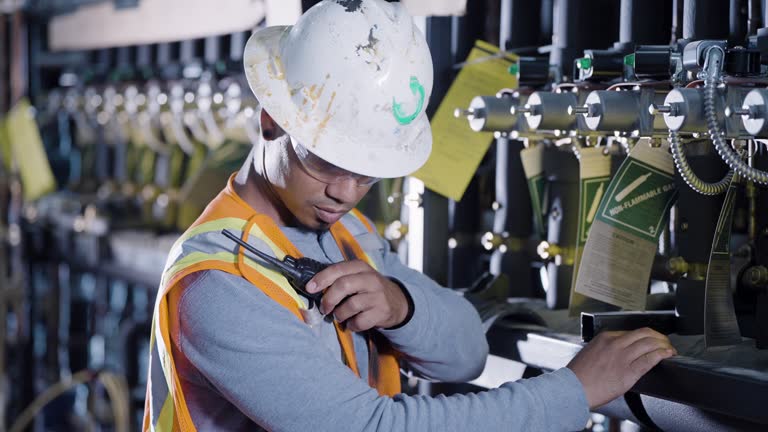 Worker inspecting industrial refrigeration equipment