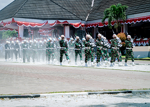 Ambon, Indonesia - August 16, 2023 : many soldiers walked neatly on the dusty ground in the Ambon city