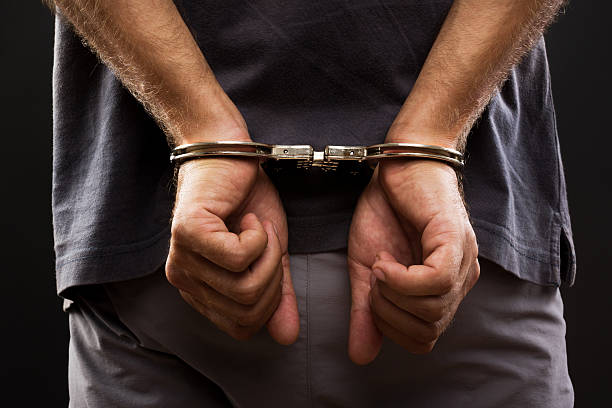 Close-up. Arrested man handcuffed Close-up. Arrested man handcuffed hands at the back detainee stock pictures, royalty-free photos & images