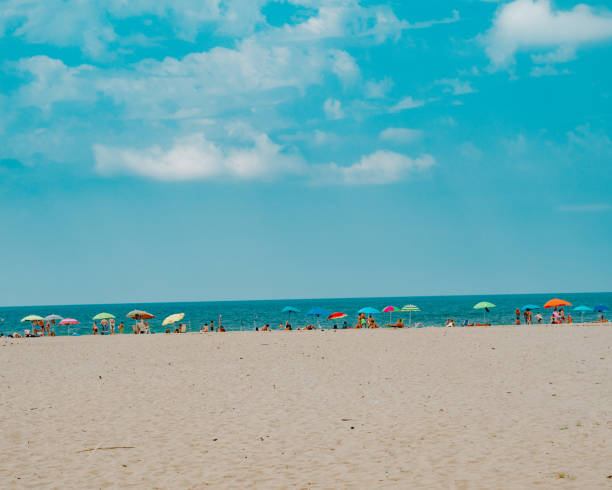 istock People enjoying at sandy beach with beautiful seascape in background 1624127814