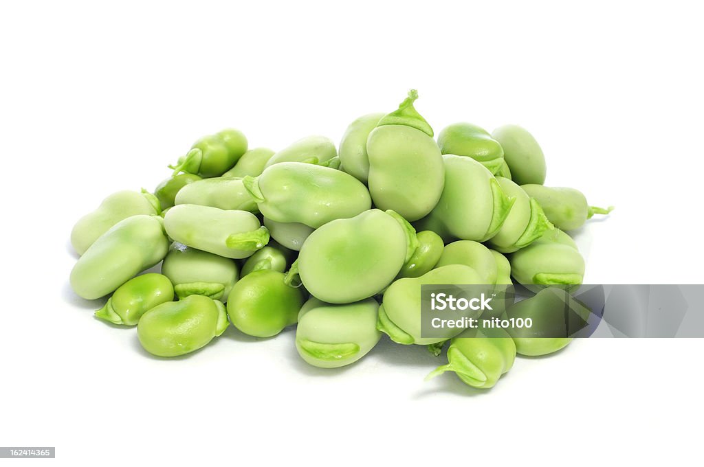 raw broad beans a pile of raw broad beans on a white background Broad Bean Stock Photo