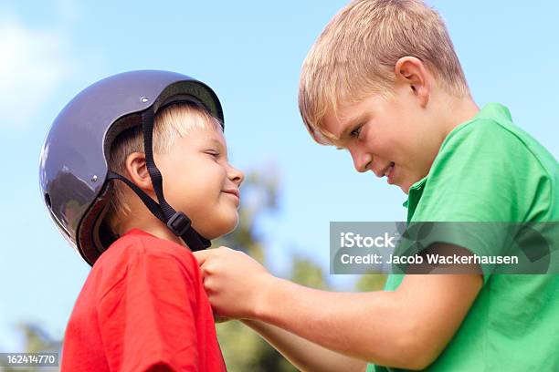 Making Sure My Little Brother Stays Safe Stock Photo - Download Image Now - Arm In Arm, Assistance, Blond Hair