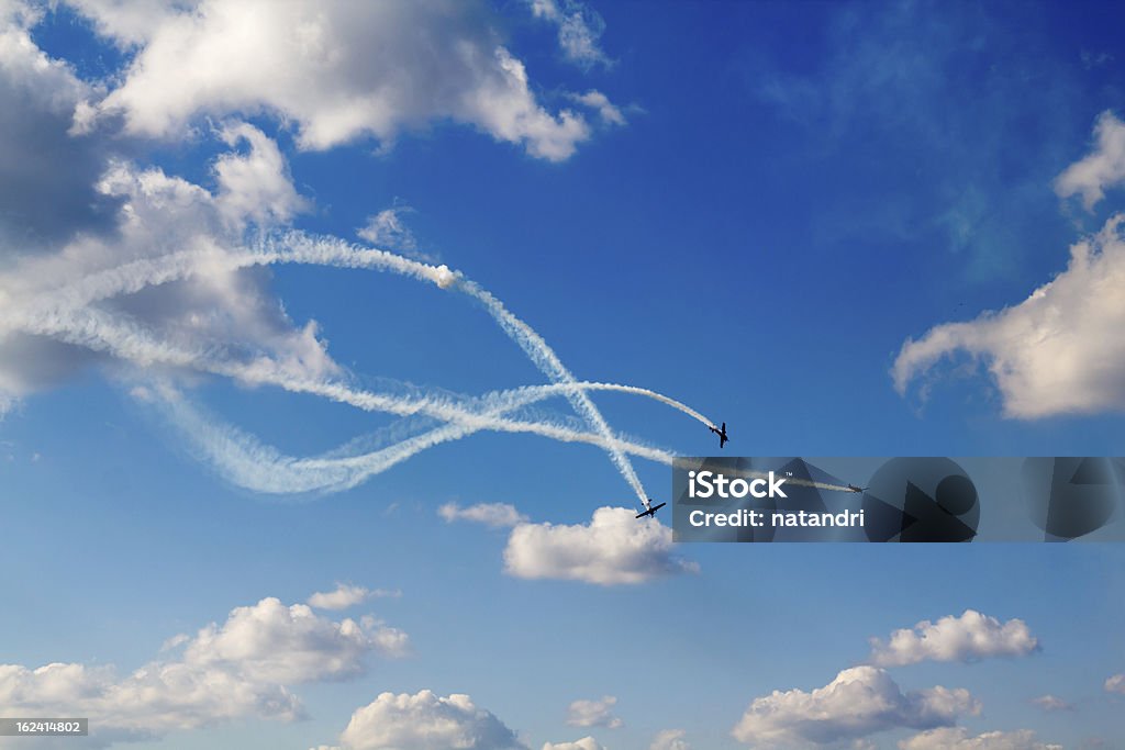 air dogfight on airshow flight of 3 planes with intersecting trails Airshow Stock Photo