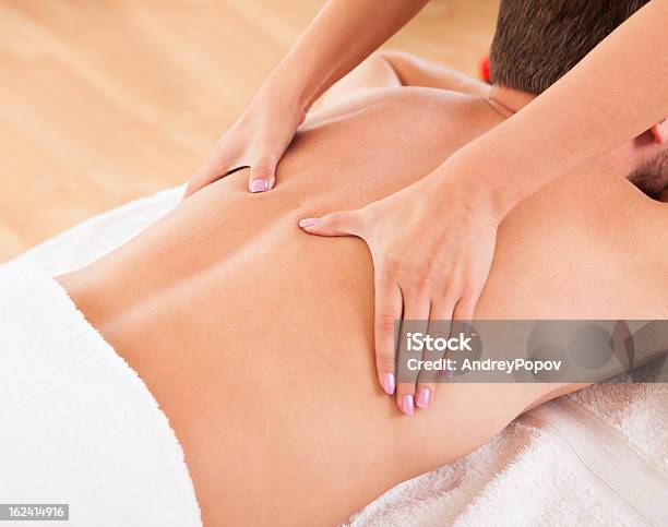 Man Having A Back Massage Stock Photo - Download Image Now - Abdomen, Achievement, Adult