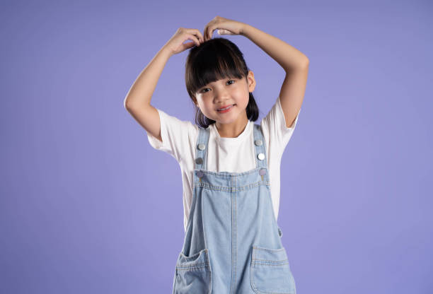 istock cute asian girl posing on purple background 1624183023