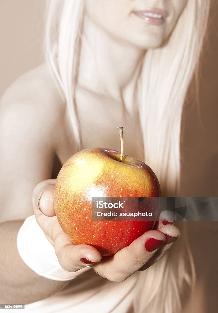 hand that suggests to take apple female hand that suggests to take apple Adult Stock Photo