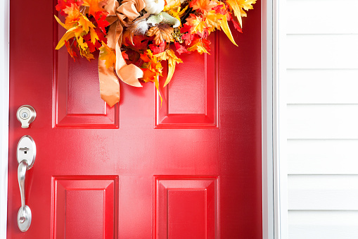 Red door with fall colours wreath