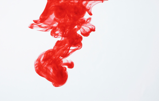 Red ink dispersing in water