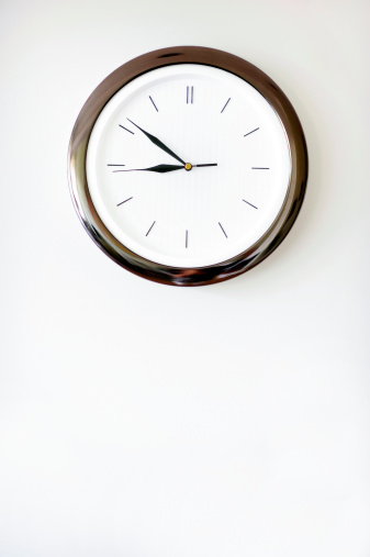 Stylish clock on a white wall