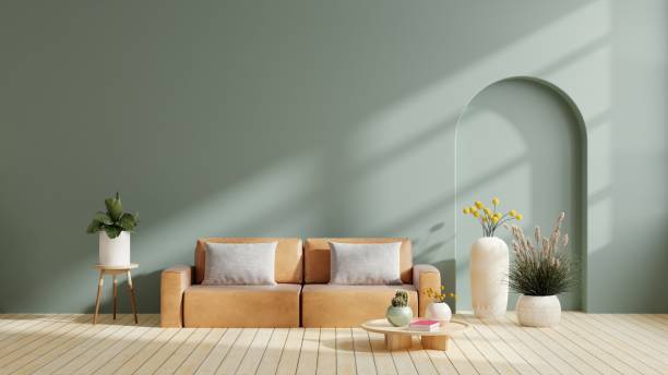 istock Modern minimalist interior with leather sofa on empty dark green color wall background. 1624298786