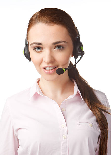 Young smiling woman with headphones in Call Centre stock photo