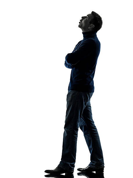 man looking up pensive silhouette full length