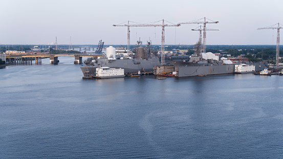 Dynamic shipyard operations near Midtown Tunnel: Gantry cranes and maritime activity in action at Nassco Shipyard, Norfolk, VA