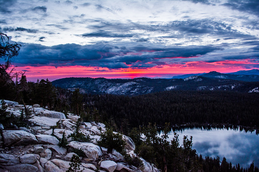 a stunning fire red sunset is on display over the vast Sierra Nevada national forest
