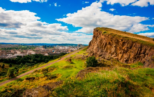 A view from Arthur's Seat to the Salisbury Crags with Edinburgh in the background.