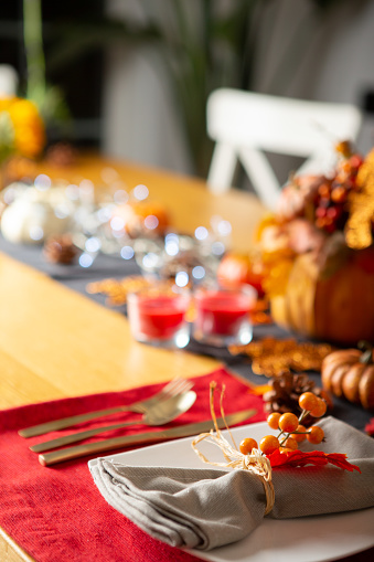 Thanksgiving wooden table setting with red placemat