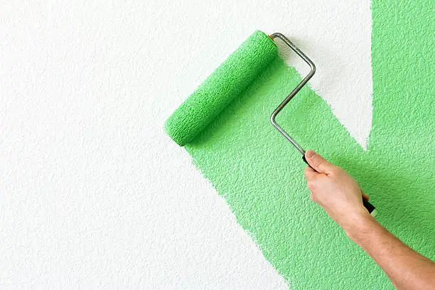 painting a wall with roller