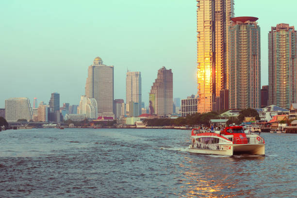 Bangkok, Thailand - November 20, 2021 : Selective focus on buildings. Chao Phraya cruise on  Chao Phraya river in Bangkok