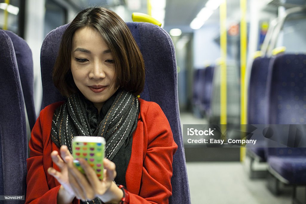 Beautiful asain women playing mobile phone on the train. Adult Stock Photo
