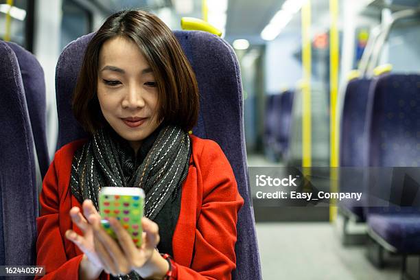 Beautiful Asain Women Playing Mobile Phone On The Train Stock Photo - Download Image Now
