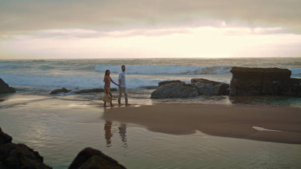 istock Affectionate couple going sea shore wide shot. People enjoying romantic time 1624418618