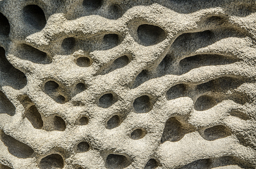 Pumice, Lava rock Stone texture full of holes and abstract pattern, dust form, is a volcanic rock that consists of highly vesicular rough-textured.