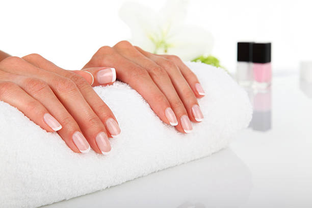 istock Manicured hands resting on a white towel 162444016