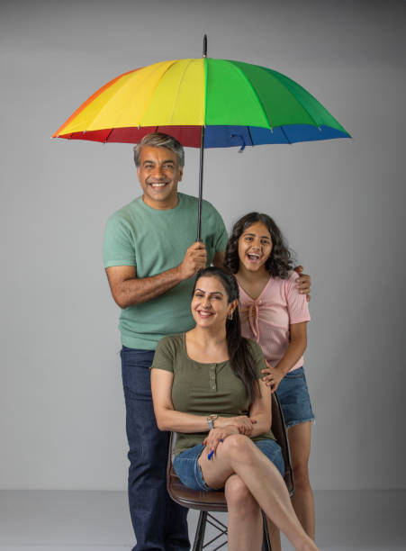 istock Parents and daughter with umbrella against white background 1624453745