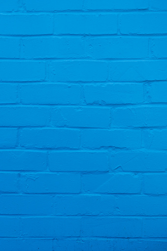 Blue coloured brick wall close up