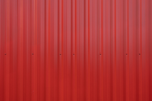 closeup shot of red coloured iron corrugated fence