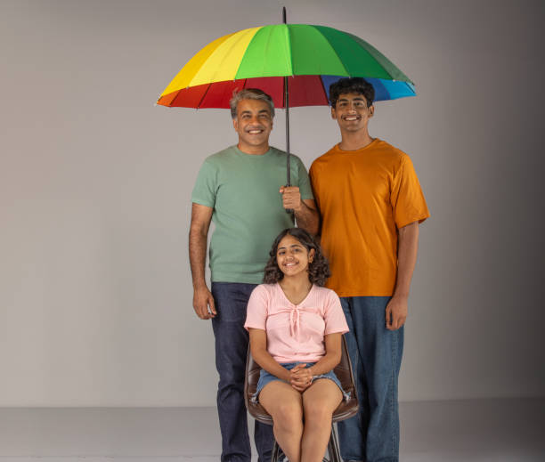 istock Father with children holding umbrella over white background 1624465725