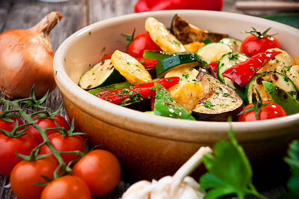 Closeup picture of oven roasted vegetables Roasted vegetables: a sweet pepper, zucchini, potatoes and eggplant in tray ratatouille stock pictures, royalty-free photos & images