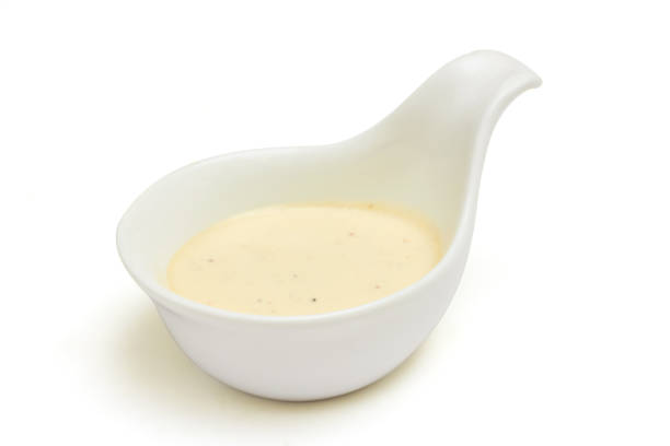 istock Mayonnaise in a spoon-shaped white sauce cup isolated on white background. Mayonnaise or egg yolk sauce is a thick sauce made from egg yolks, oil and vinegar. Color is white, light yellow, or cream. 1624481293