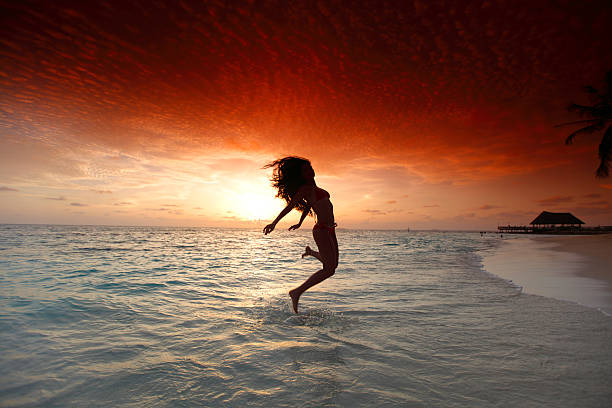 istock Woman jumping on beach 162449412