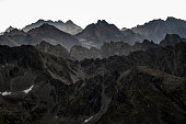 Dark silhouettes of the High Tatras from the Mount Krivan at sunrise. Tatra Mountains, Slovakia.