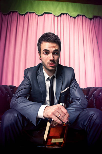 istock Drunk businessman with a bottle of strong alcohol 162452617