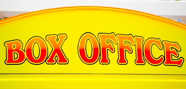 Box office sign in yellow, orange and red color, heatre, cinema, or concert hall is the place where the tickets are sold.