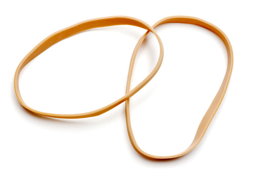Two large rubber bands over lapping and isolated on white background.