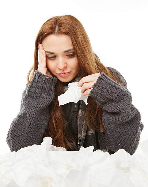 Young a cold woman, upset, holding handkerchief stock photo