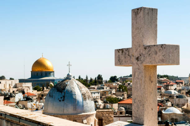 This is the ninth station of the Via Dolorosa in Jerusalem, traditionally marking the place where Jesus fell for the third time. The Church of St. Anthony is located here, with the dome of the Church of the Holy Sepulchre visible in the background.