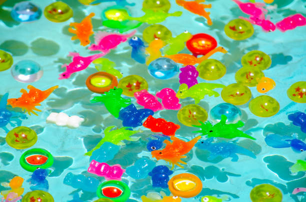 istock Colorful plastic toys have Floating on clear water pool for background. 1624556306