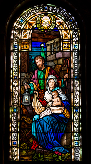 Holy family in stained glass window of a church
