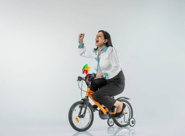 istock Cheerful woman riding bicycle on white background 1624592383