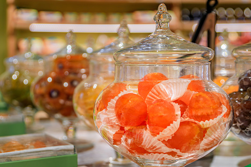 Whole candied clementine citrus fruit on display at a confectionery store in the medieval town of Saint Paul de Vence, French Riviera, South of France
