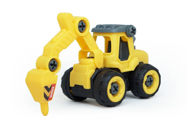 istock yellow plastic tractor drill toy isolated on white background. heavy construction vehicle. 1624629052