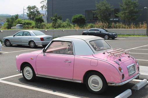 Gapyeong, South Korea-August 19, 2023: Pink vintage car, in cafe parking lot