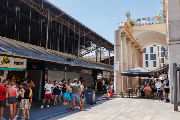 people walking and standing around the food stands of la boqueria, the famous food market in barcelona near rambla, spain - store street barcelona shopping mall imagens e fotografias de stock