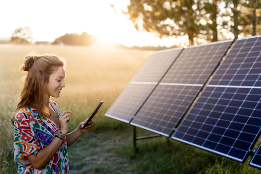 A Young Farmer Woman Checking Informations At Solar Station