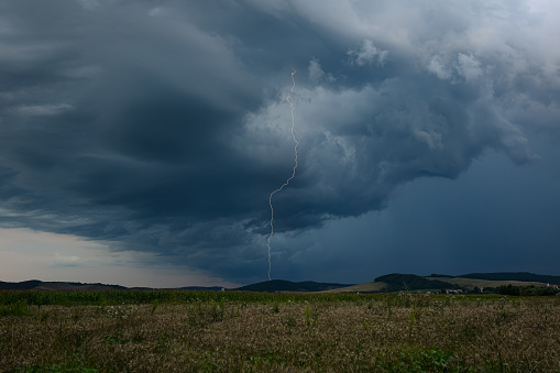 Lightning strikes down from a dramatic looking thunderstorm over the countryside of Transylvania in eastern Europe.
