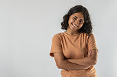 Smiling teenage girl with arms crossed over white background